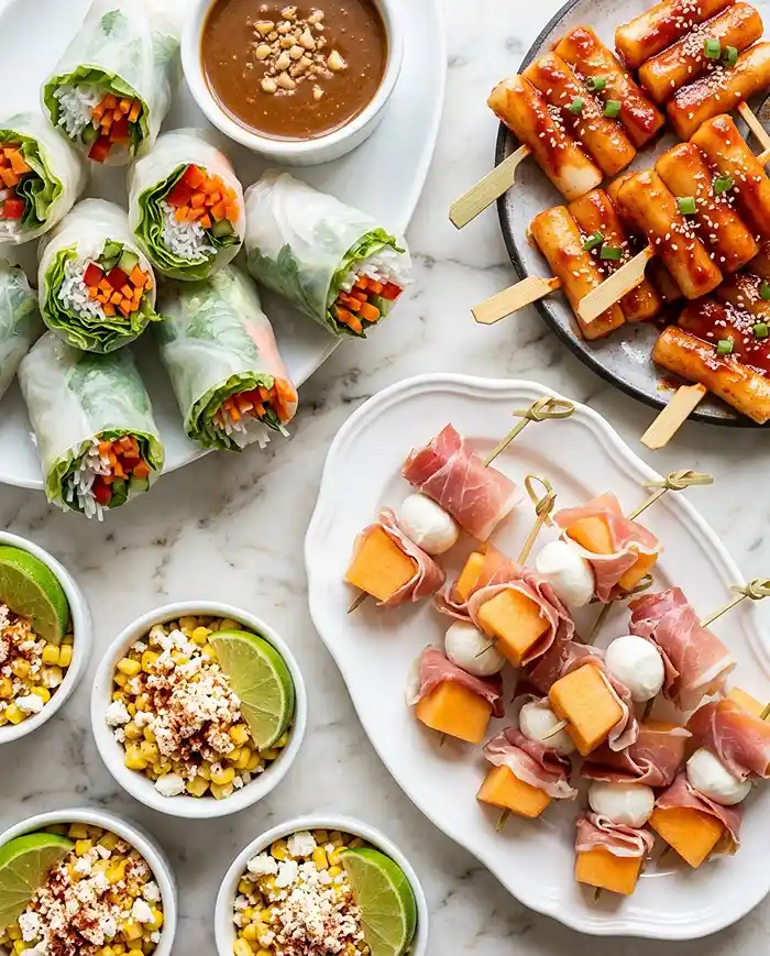 Gluten Free Snacks for Party 5 Gluten free party snacks on skewers and in cups, with spring rolls, tteokkochi, and elote cups